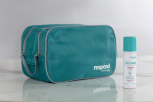 A Respond stoma supplies travel bag sits on a marble countertop alongside a bottle of REFRESH 3 in 1 - ready to take on the world!